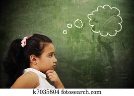 Education activities in classroom at school, smart girl thinking, copy space Education activities in classroom at school, smart girl thinking, copy space