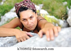 Female climbing rock on the top of mountain Female climbing rock on the top of mountain