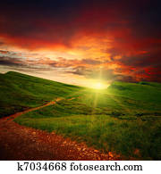 majestic sunset and path through a meadow