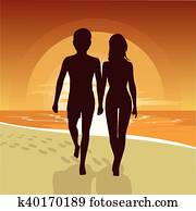silhouette of happy couple walking along beach at sunset silhouette of happy couple walking along beach at sunset