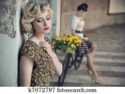 Retro style photo of two young beauties