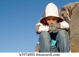 sad, lonely, unhappy , grieving, child sitting alone