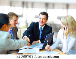 Business people shaking hands, finishing up a meeting Business people shaking hands, finishing up a meeting