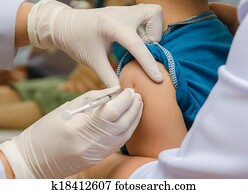 Doctor give injection of vaccine to boy's arm Doctor give injection of vaccine to boy's arm