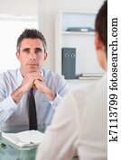 Portrait of a serious manager interviewing an applicant