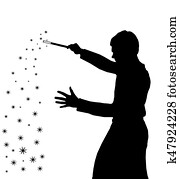 Silhouette of teenage boy wizard creating magic Silhouette of teenage boy wizard creating magic