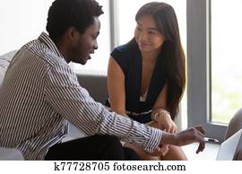African American businessman mentor training Asian female intern close up African American businessman mentor training Asian female intern close up