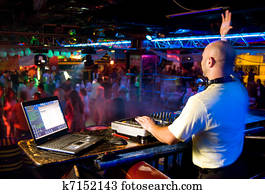 Dj mixes the track in the nightclub at a party Dj mixes the track in the nightclub at a party
