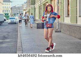 White woman walks in city center. White woman walks in city center.