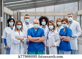 Group of doctors with face masks looking at camera, corona virus concept. Group of doctors with face masks looking at camera, corona virus concept.