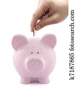 Putting coin into the piggy bank Putting coin into the piggy bank
