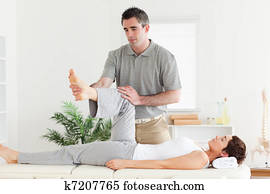 Chiropractor working with a customer Chiropractor working with a customer