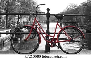 Red European Bike next to river. Red European Bike next to river.