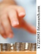 Businessman hand reaching for pennies