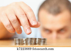 Businessman hand reaching for pennies