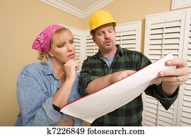 Contractor in Hard Hat Discussing Plans with Woman Contractor in Hard Hat Discussing Plans with Woman