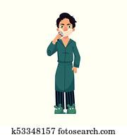 Young man in bathrobe and pajamas shaving beard Young man in bathrobe and pajamas shaving beard