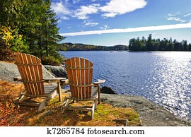 Adirondack chairs at lake shore Adirondack chairs at lake shore