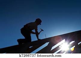 Builder or carpenter working on the roof Builder or carpenter working on the roof