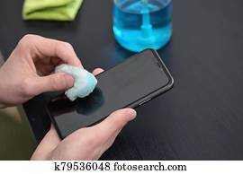 Man Cleaning Smartphone Screen With Alcohol Man Cleaning Smartphone Screen With Alcohol