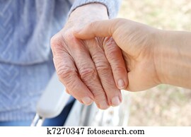 Holding senior's hand Holding senior's hand