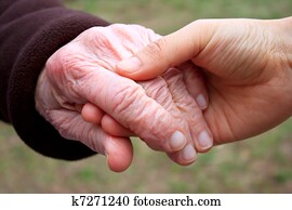 Senior and young holding hands