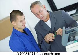 trainee technician learning his trade with mentor trainee technician learning his trade with mentor
