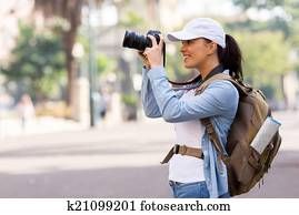 young female tourist taking pictures