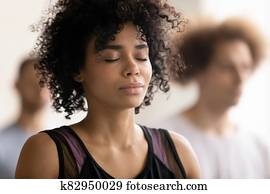 Young peaceful african american woman enjoying deep meditation. Young peaceful african american woman enjoying deep meditation.