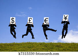 businessman jumping  and holding 4 different currency signs. dollor, pond, euro,yen 