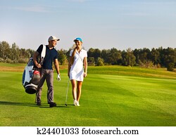 Young sportive couple playing golf Young sportive couple playing golf