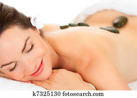 Beautiful woman getting hot stone massage Beautiful woman getting hot stone massage