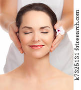 Beautiful young woman getting facial massage Beautiful young woman getting facial massage