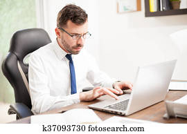 Businessman with glasses working on a laptop
