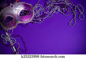 Purple Mardi-Gras or Venetian mask on purple background Purple Mardi-Gras or Venetian mask on purple background