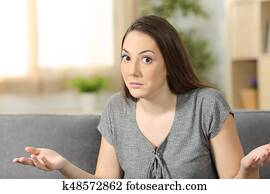 Doubtful woman looking at camera