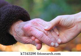 Holding seniors hand Holding seniors hand