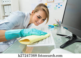 Maid Cleaning Keyboard At Desk Maid Cleaning Keyboard At Desk