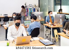 Social distance office with business team wear face mask as new normal life