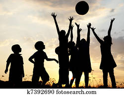 Silhouette, group of happy children playing on meadow, sunset, summertime Silhouette, group of happy children playing on meadow, sunset, summertime