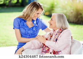 Affectionate Granddaughter And Grandmother At Nursing Home Porch