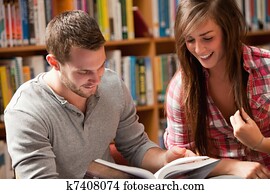 Students reading a book Students reading a book