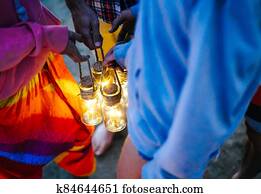 Hipster friends having fun while camping with tent on the beach - Young people holding bright lanterns in campsite on summer - Concept of friendship, travel, vacation and youth lifestyle Hipster friends having fun while camping with tent on the beach - Young people holding bright lanterns in campsite on summer - Concept of friendship, travel, vacation and youth lifestyle