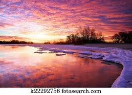 Winter landscape with lake and sunset fiery sky. Composition of Winter landscape with lake and sunset fiery sky. Composition of