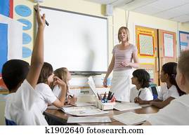 A teacher teaching a junior school class A teacher teaching a junior school class