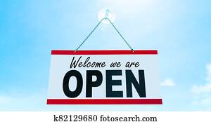 COVID-19 Open business sign saying Welcome we are OPEN hanging on window storefront reopening Retail businesses opening again. Sun blue sky summer background. end of confinement COVID-19 Open business sign saying Welcome we are OPEN hanging on window storefront reopening Retail businesses opening again. Sun blue sky summer background. end of confinement