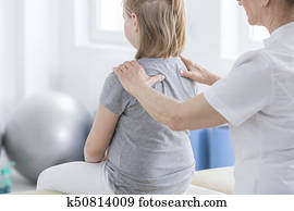 Physiotherapist doing massage to girl Physiotherapist doing massage to girl