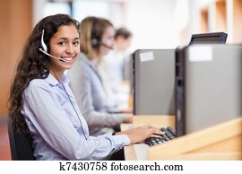 Smiling assistant working with a computer Smiling assistant working with a computer