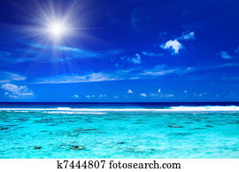 Sun over tropical ocean with vibrant colors