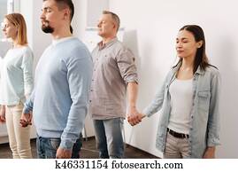 Photo of delighted coworkers standing in semi position